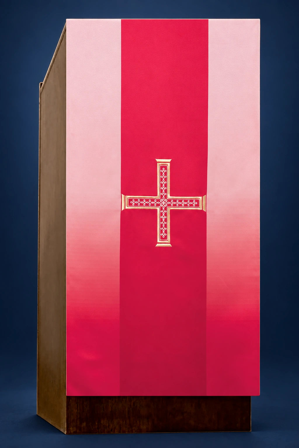 Front view of a red lectern cover with a centered embroidered cross and vertical paneling