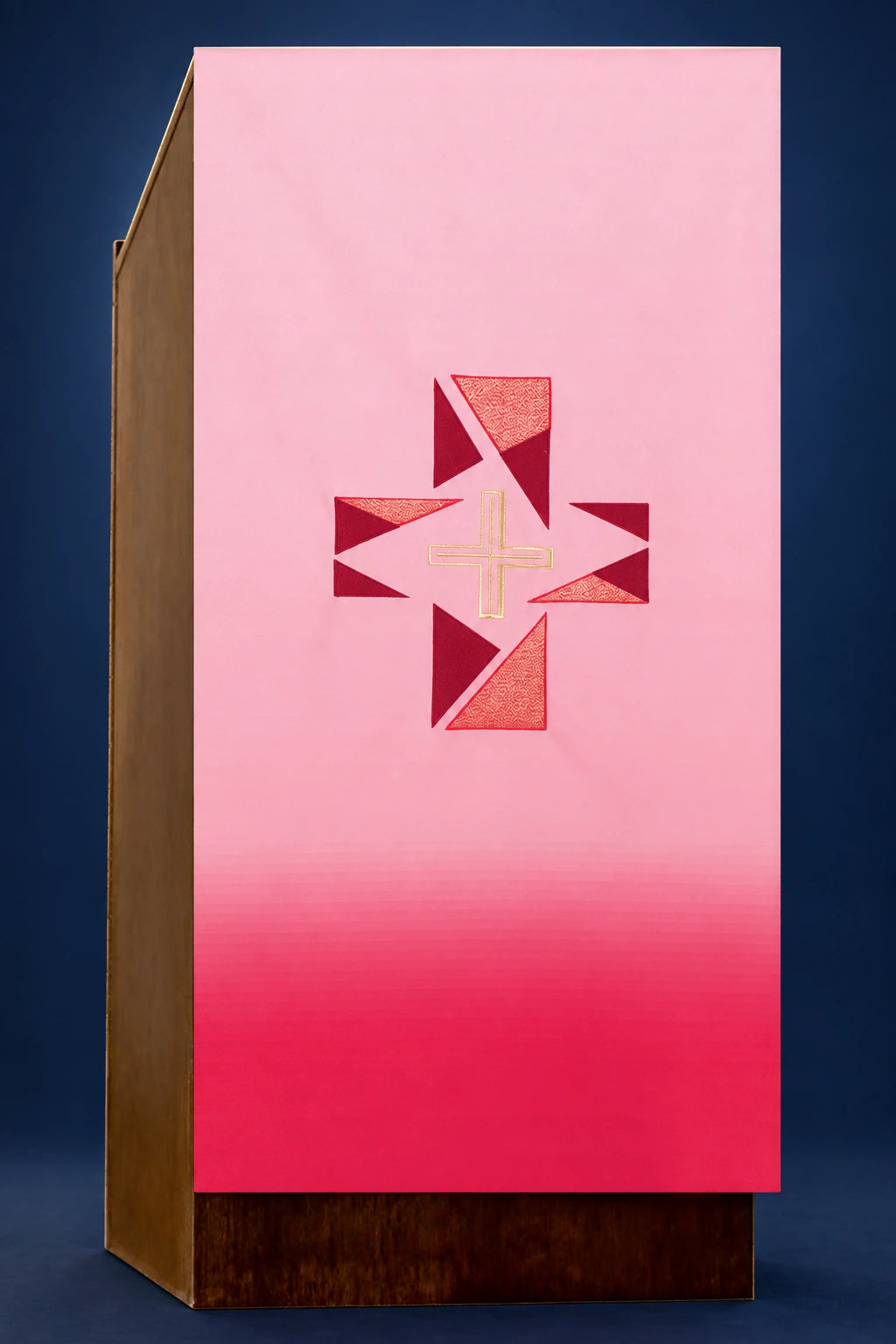 Front view of a red lectern cover with a central cross motif and geometric triangular panels
