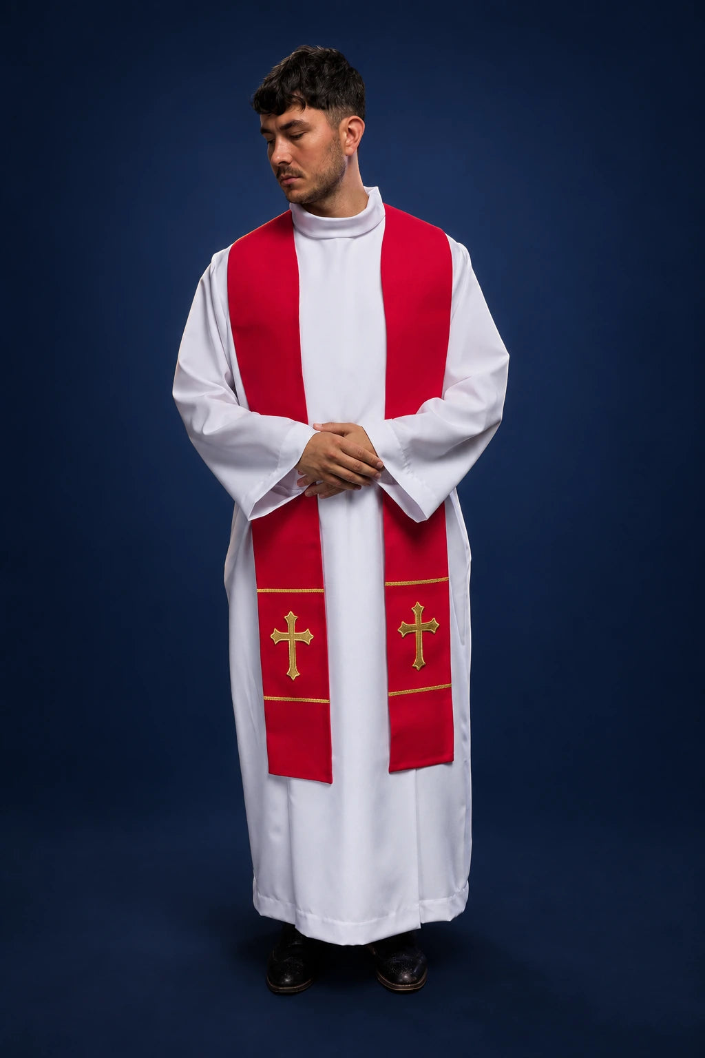 Front view of a red priest stole with gold embroidered crosses, worn over a white alb