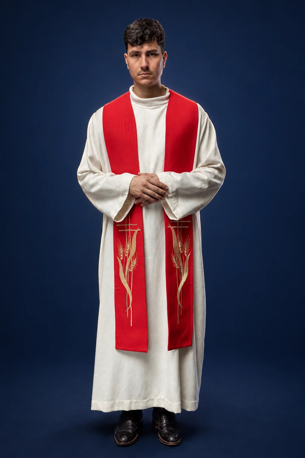 Front view of a red priest stole with gold wheat embroidery, worn over a white alb