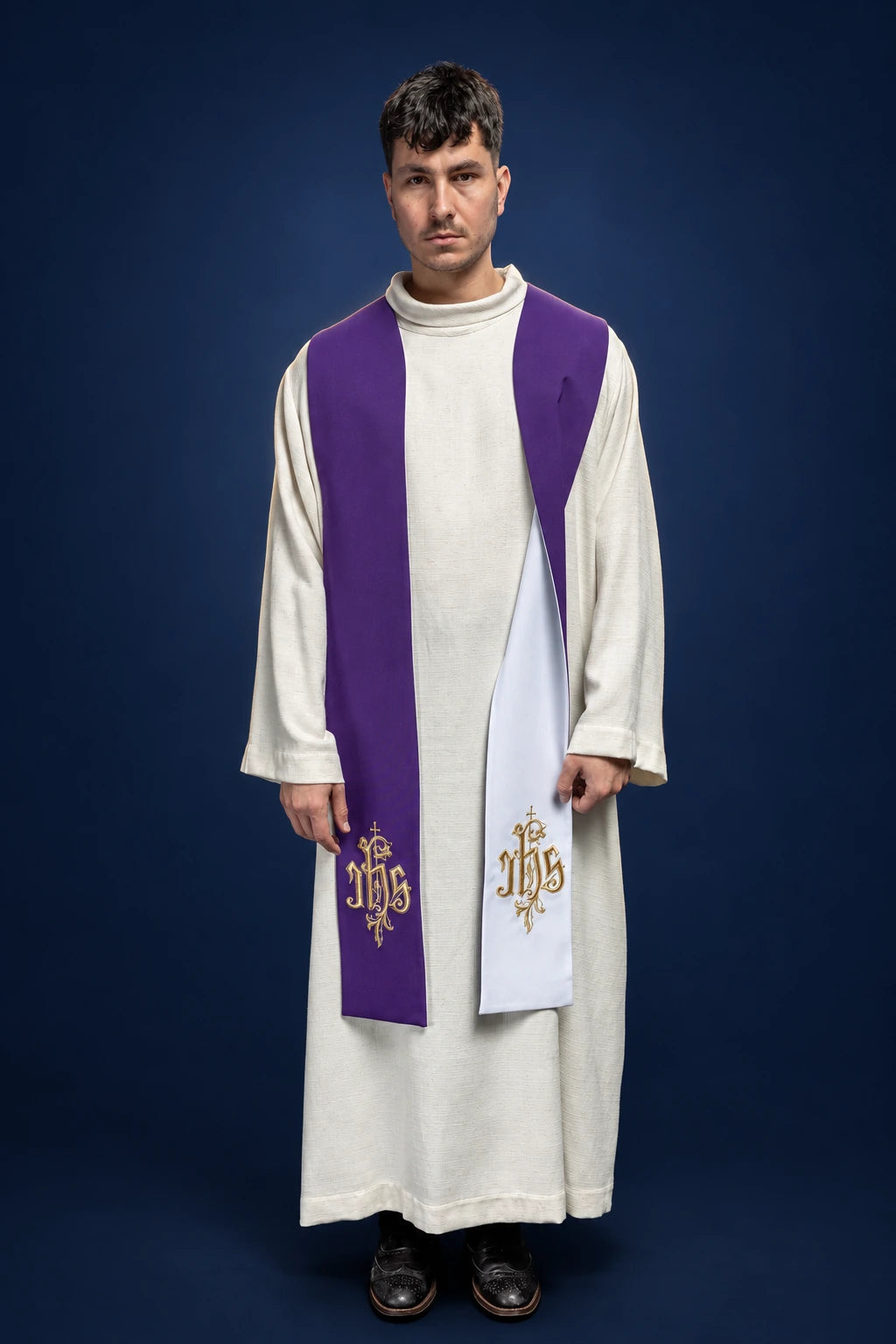 Front view of reversible purple and white stole with embroidered IHS at the lower ends
