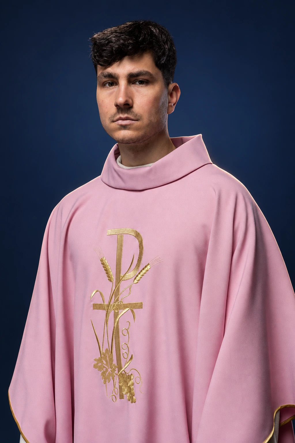 Front view of a rose chasuble with gold cross and vine embroidery on the chest