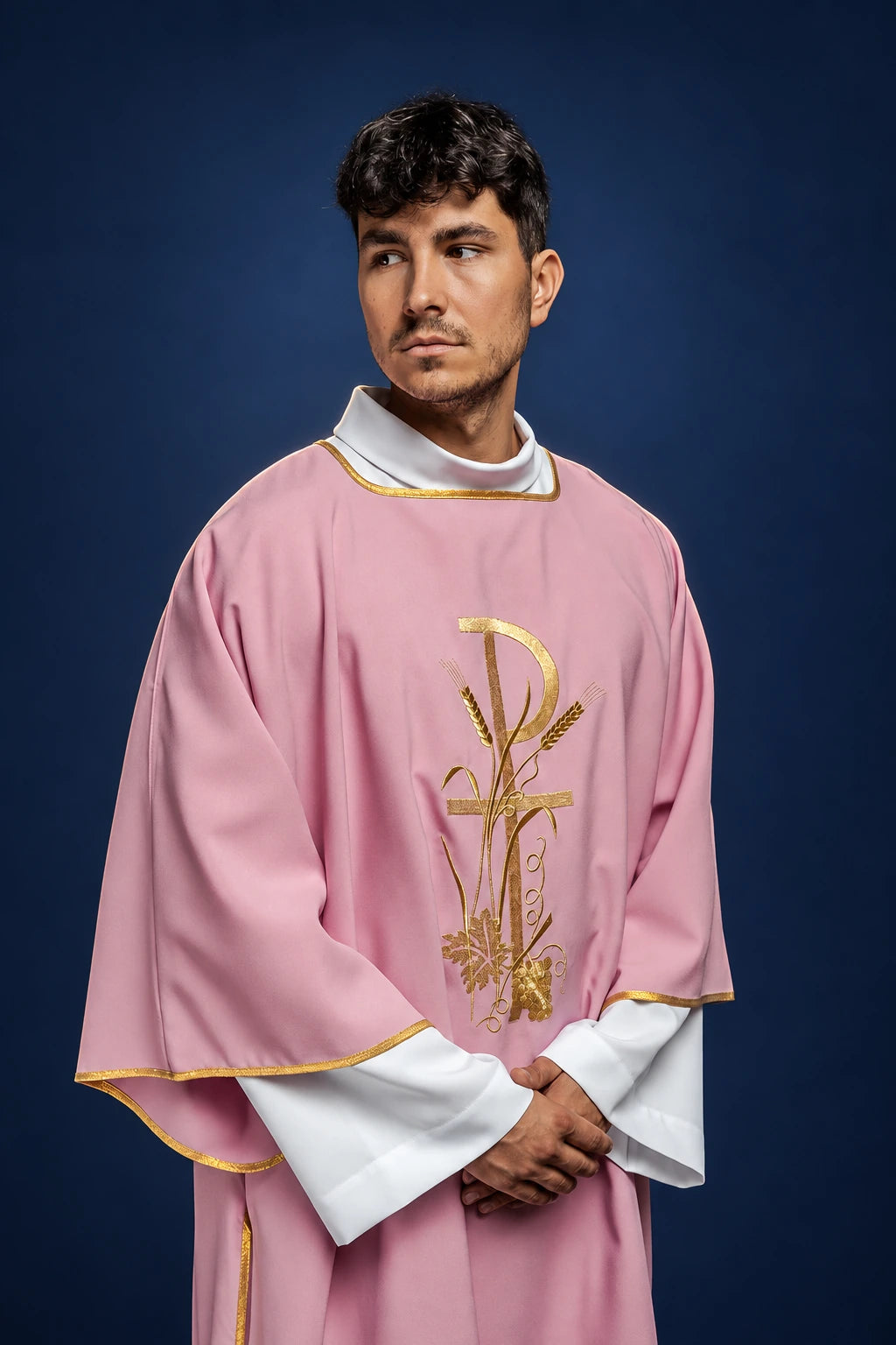 Front view of a rose dalmatic with gold PAX cross embroidery and gold trim on the sleeves and hem
