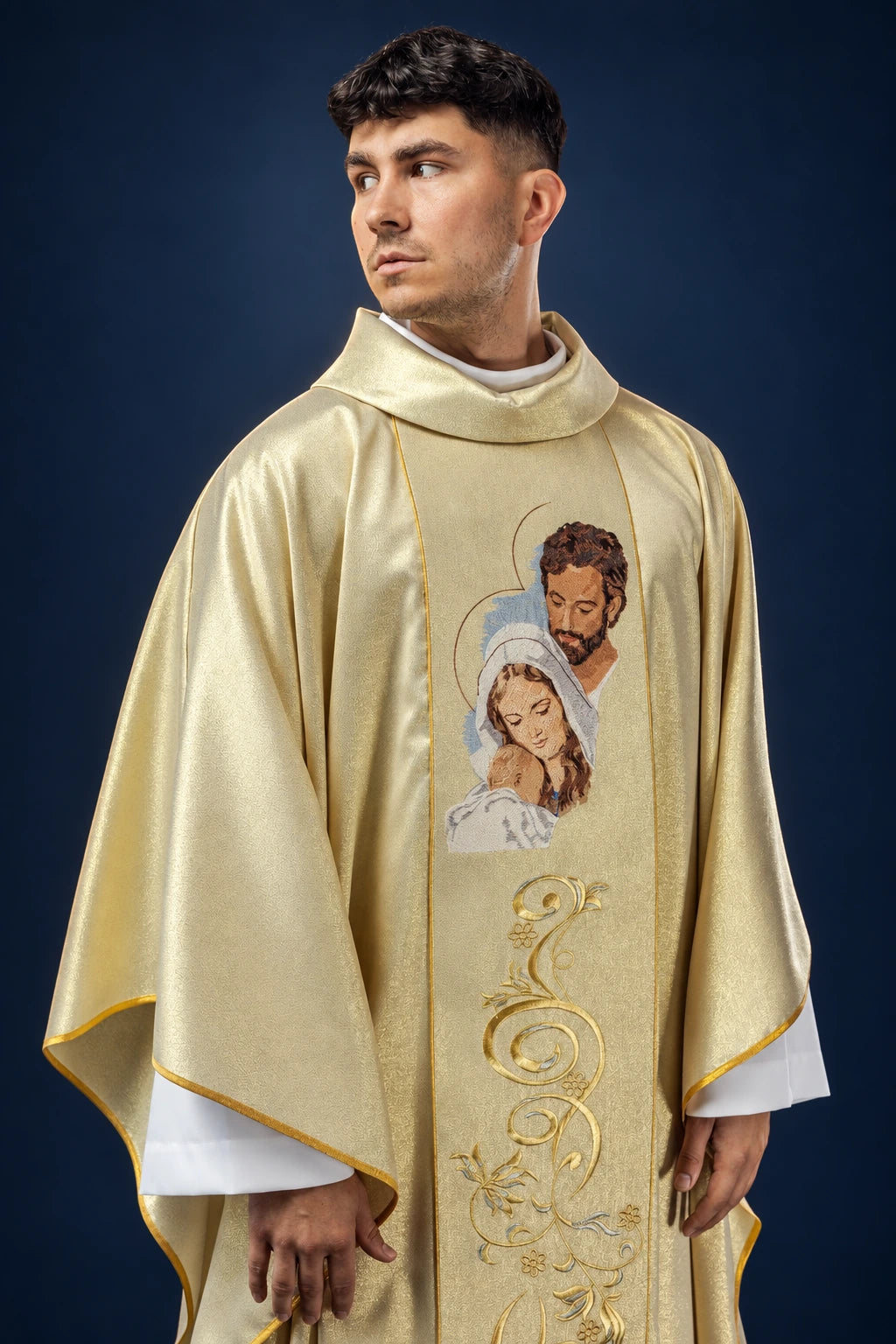 Front view of a shimmering gold chasuble with embroidered Holy Family image and ornate scrollwork
