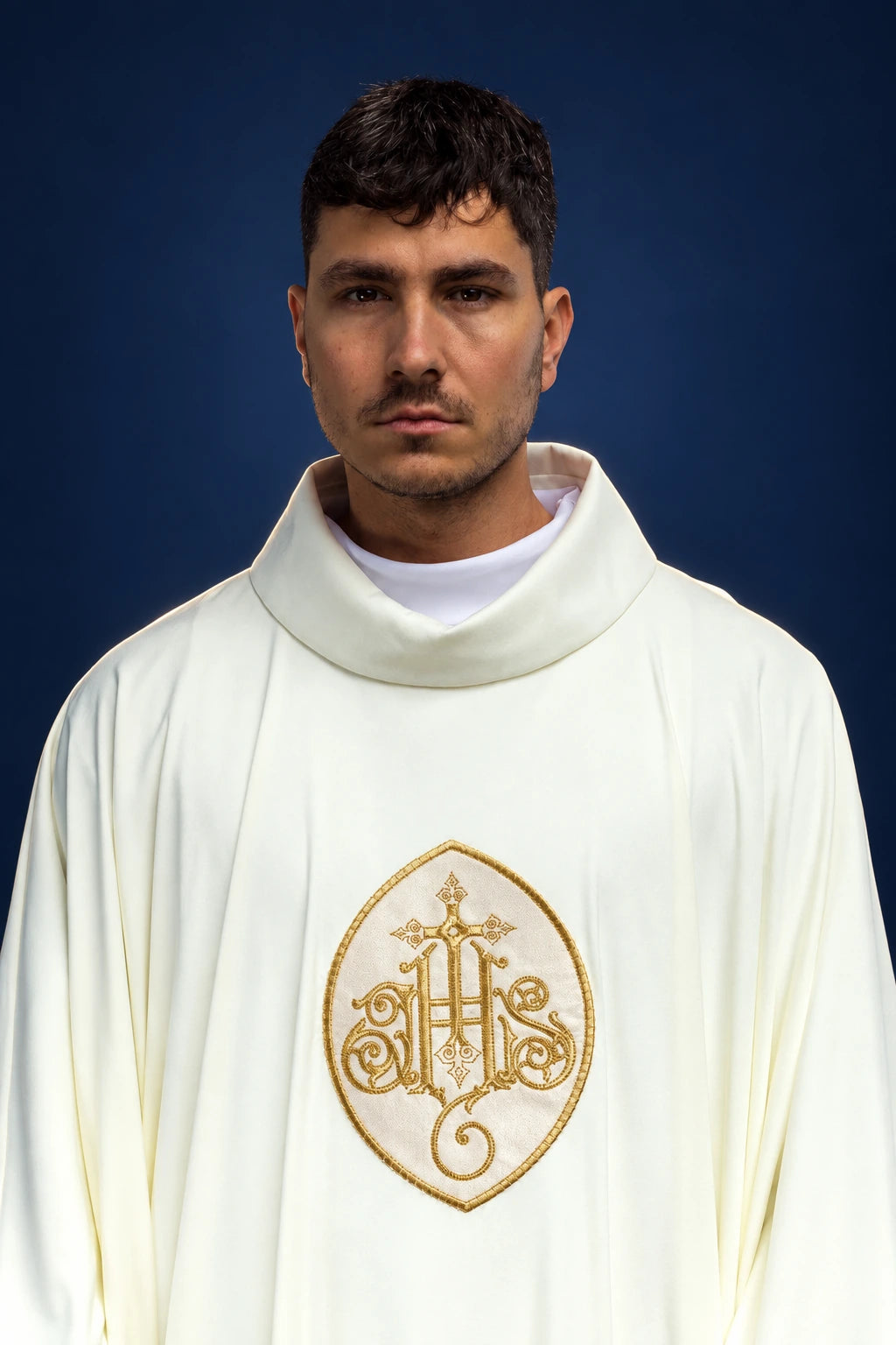 Front view of a white chasuble with gold IHS embroidery at the chest