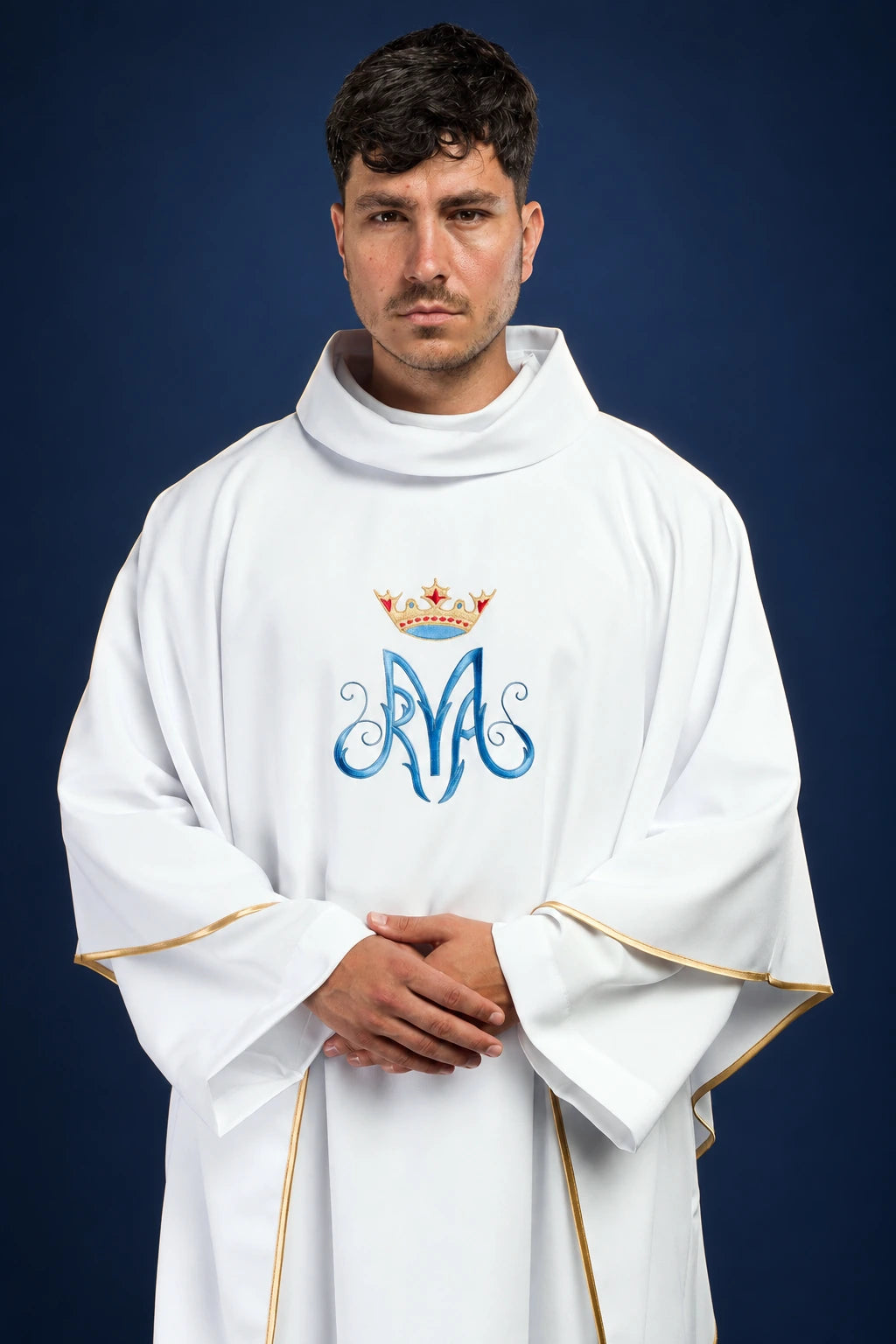 Front view of a white chasuble with gold trim and Marian monogram embroidery on the chest