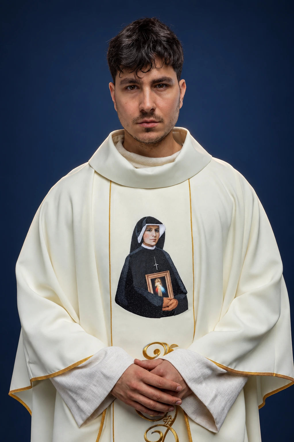 Front view of a white chasuble with gold trim and Saint Faustina embroidered on the front panel