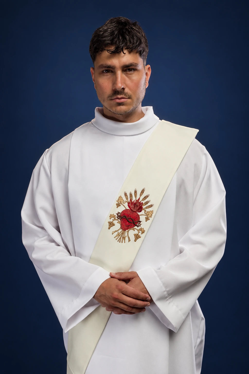 Front view of a white deacon stole with embroidered Sacred Heart of Jesus motif worn over a white alb