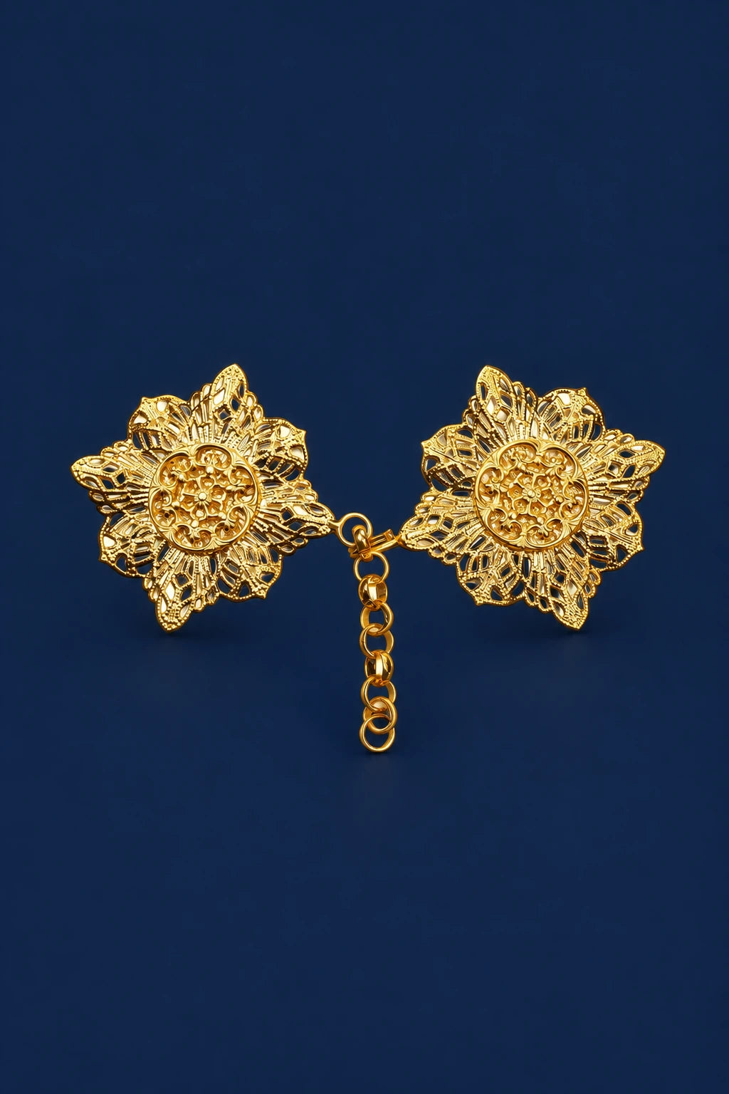 Gold flower-shaped cope clasp with two filigree floral medallions linked by a short chain