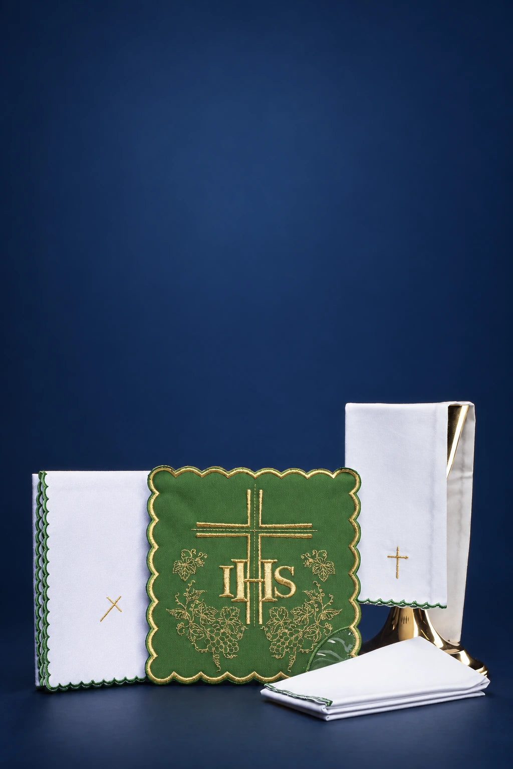Green altar linen set with gold IHS embroidery, shown with folded purificator, corporal, pall, and towel