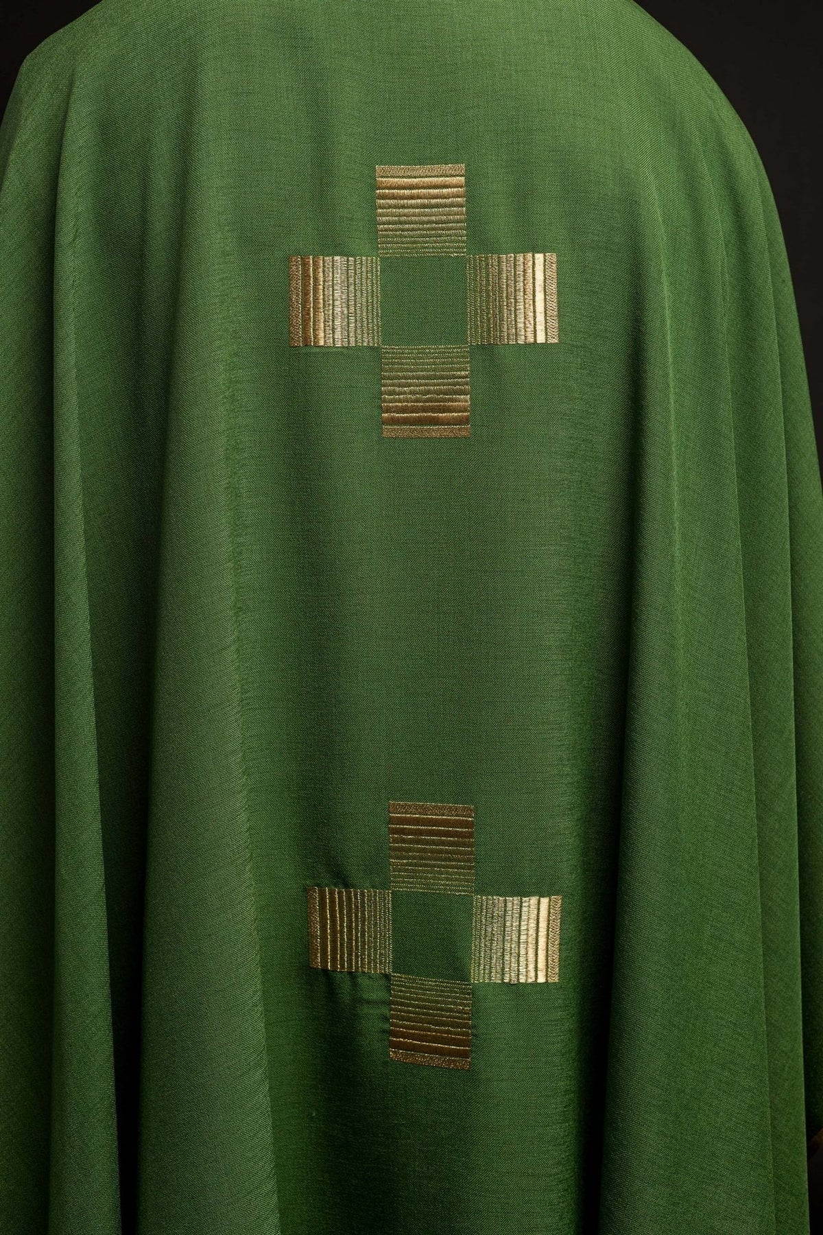Green chasuble back detail showing two gold embroidered crosses