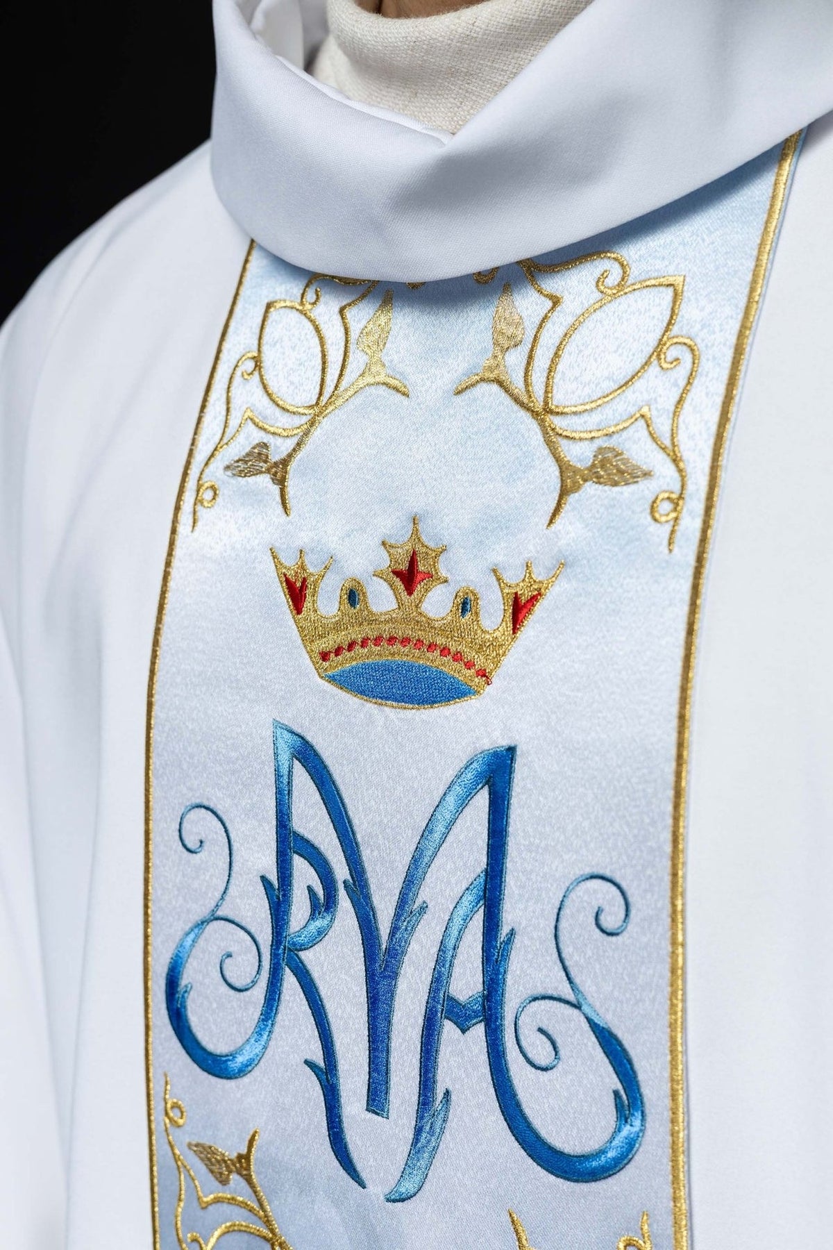 Marian chasuble close-up of white stand-up collar and embroidered gold crown above blue Marian symbol