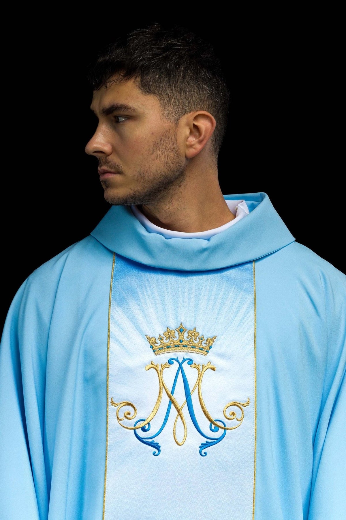 Blue Marian chasuble close-up showing stand-up collar and crowned Marian symbol