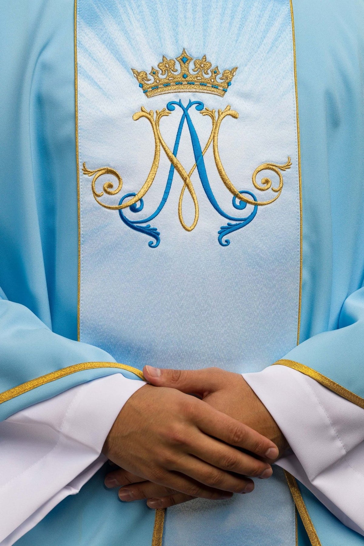 Blue Marian chasuble close-up of embroidered crowned Marian symbol on the front orphrey