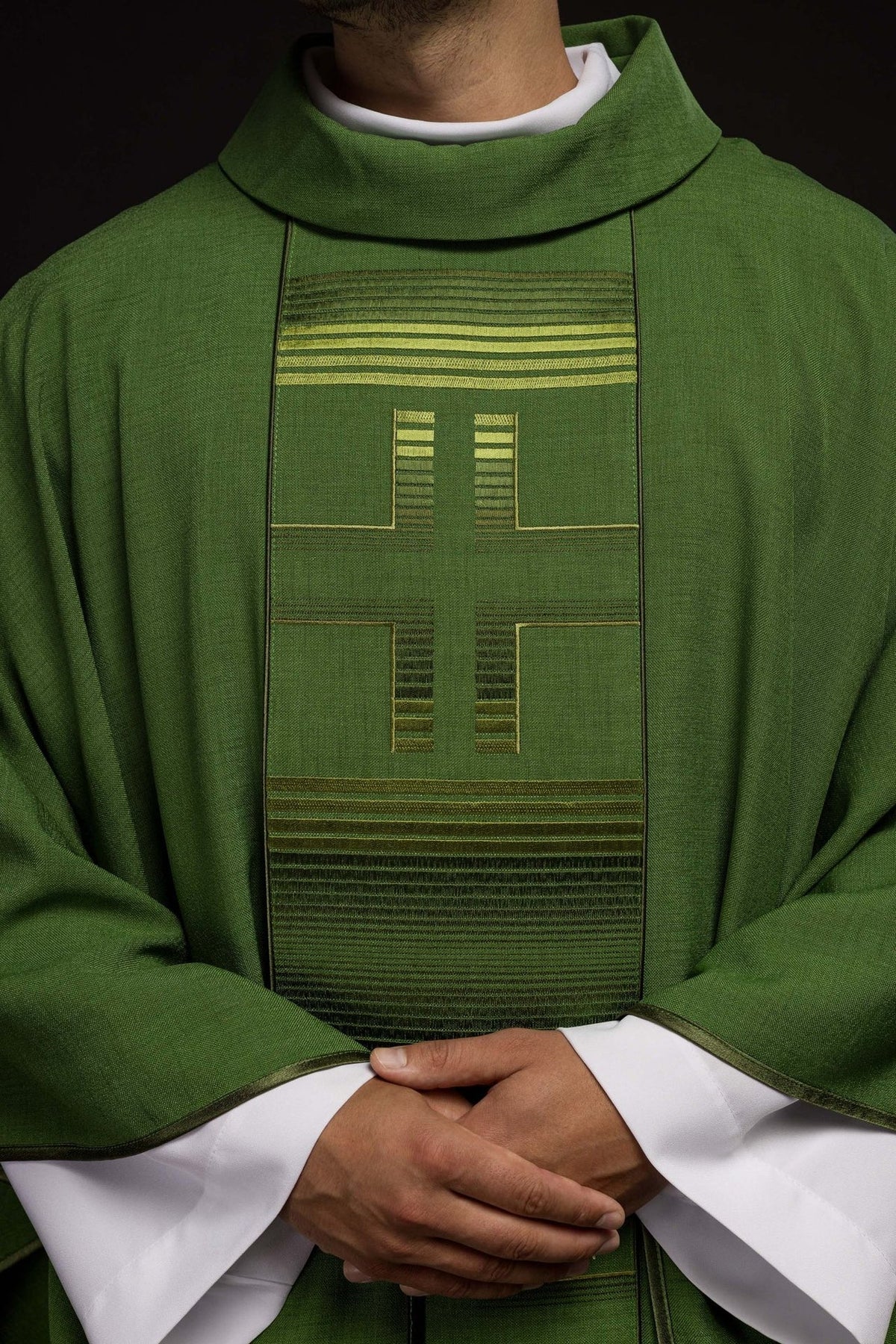 Green chasuble front close-up with embroidered cross and horizontal trim