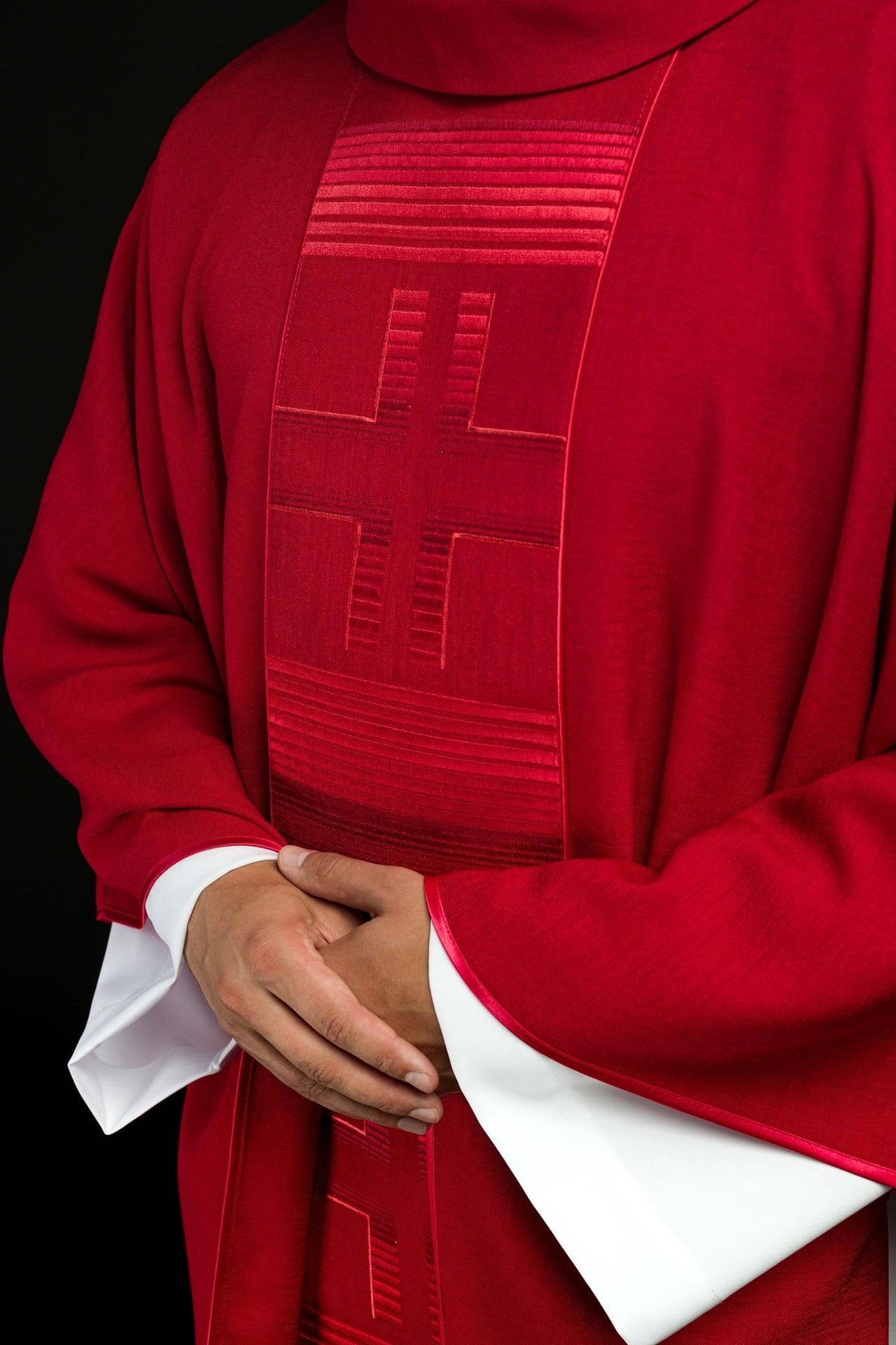 Red chasuble front close-up with embroidered cross and horizontal trim