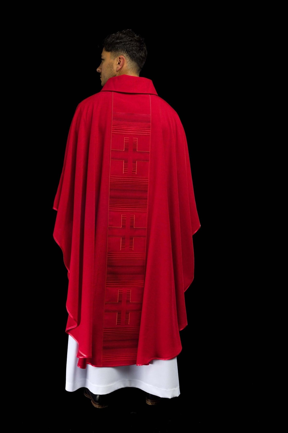 Red chasuble worn from the back with embroidered crosses