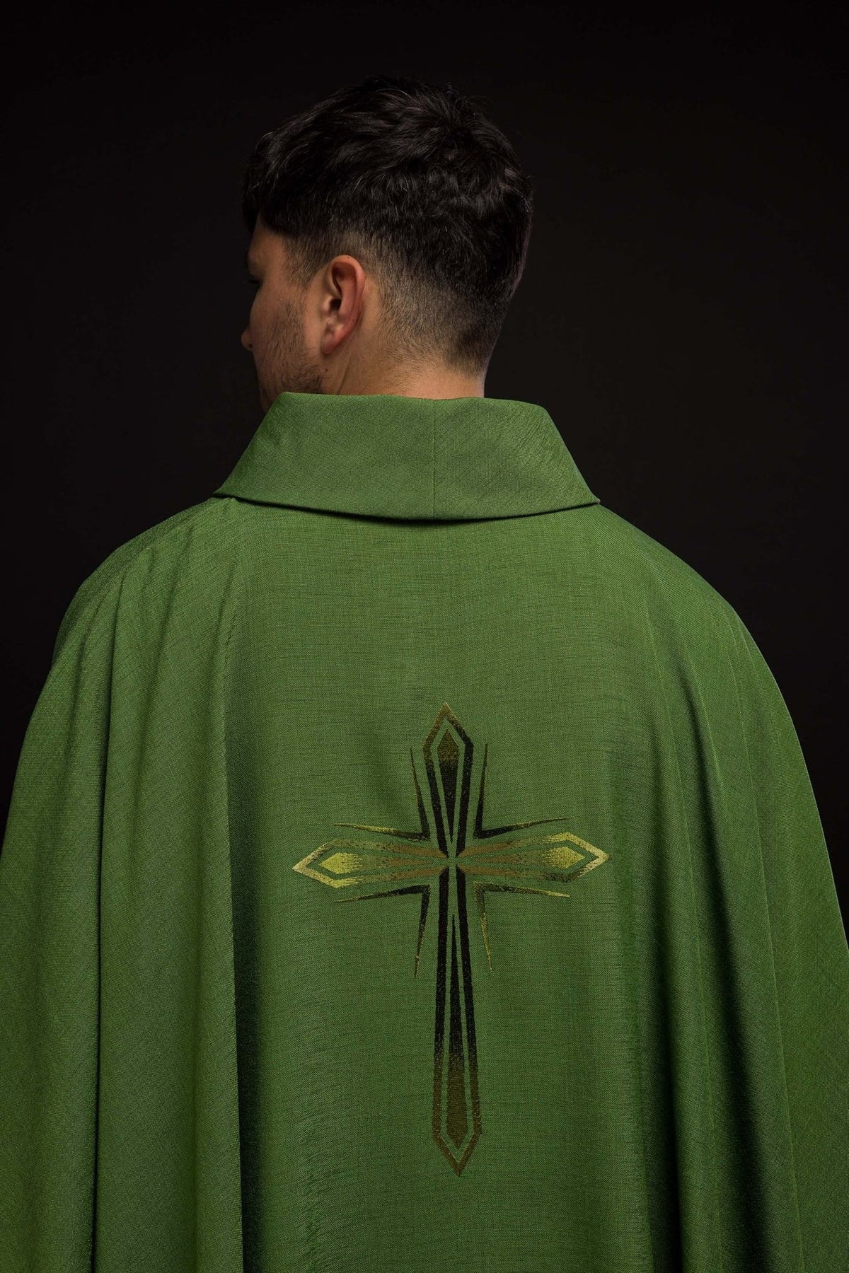 Green chasuble shown from the back with an embroidered cross