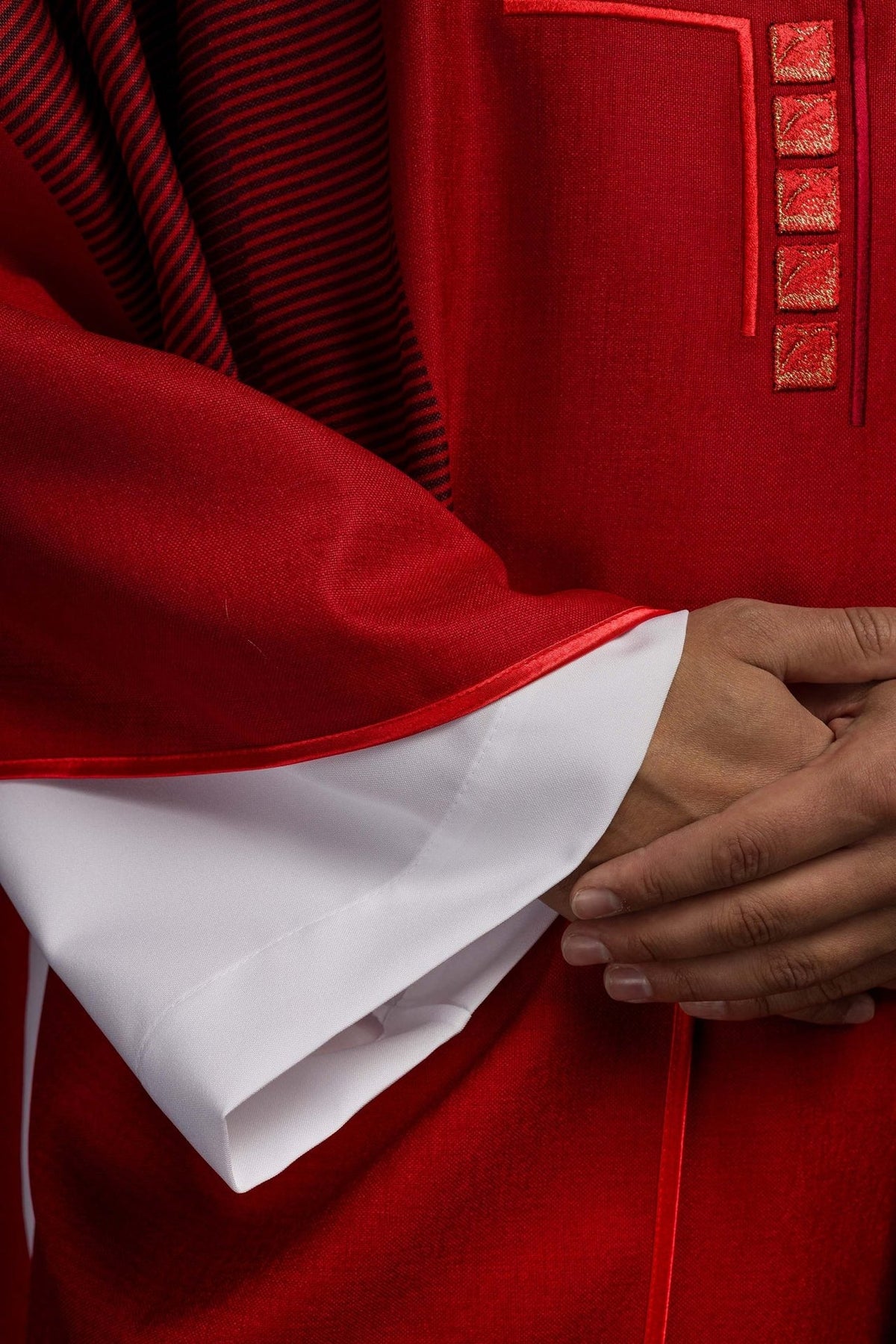 Red chasuble close-up of red trim and striped side fabric