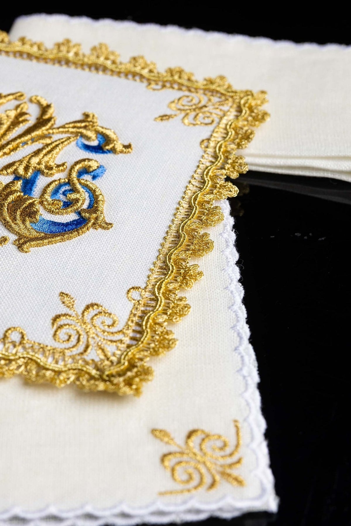 Altar linen set close-up showing ornate gold trim and scalloped linen edge