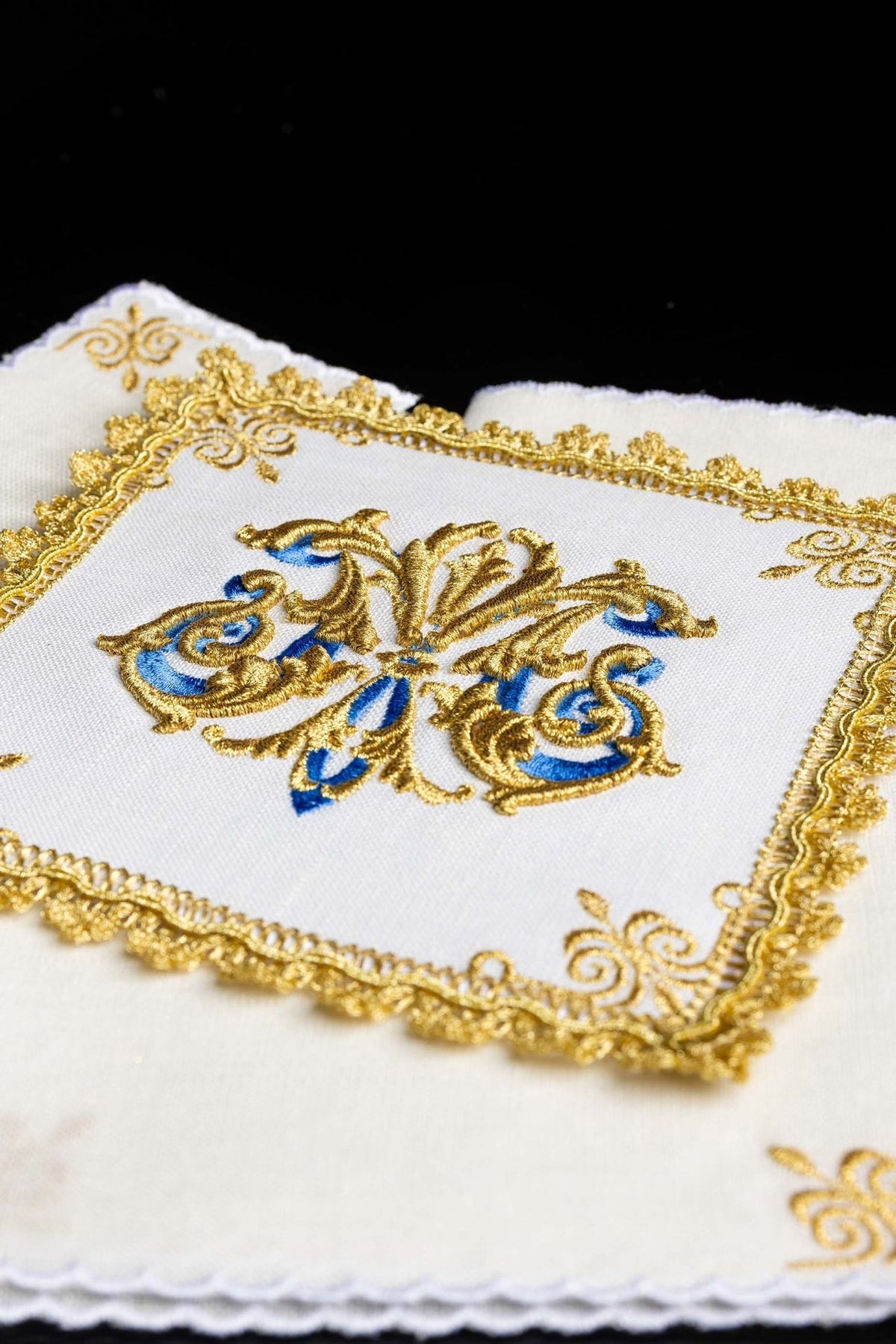 Altar linen set detail with gold border embroidery and blue Marian symbol