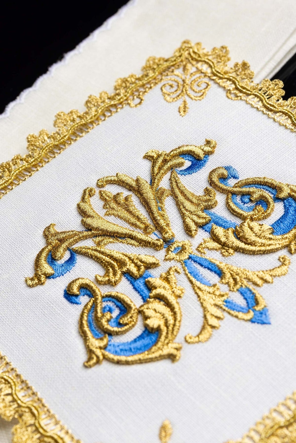 Altar linen set detail showing gold embroidery and ornate edge trim