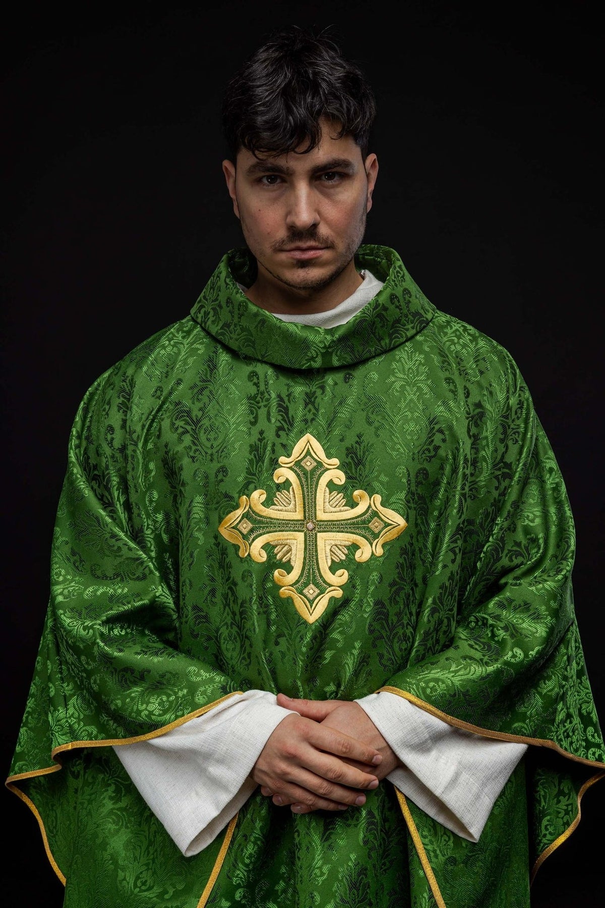 Green chasuble worn front view with gold embroidered cross and gold trim