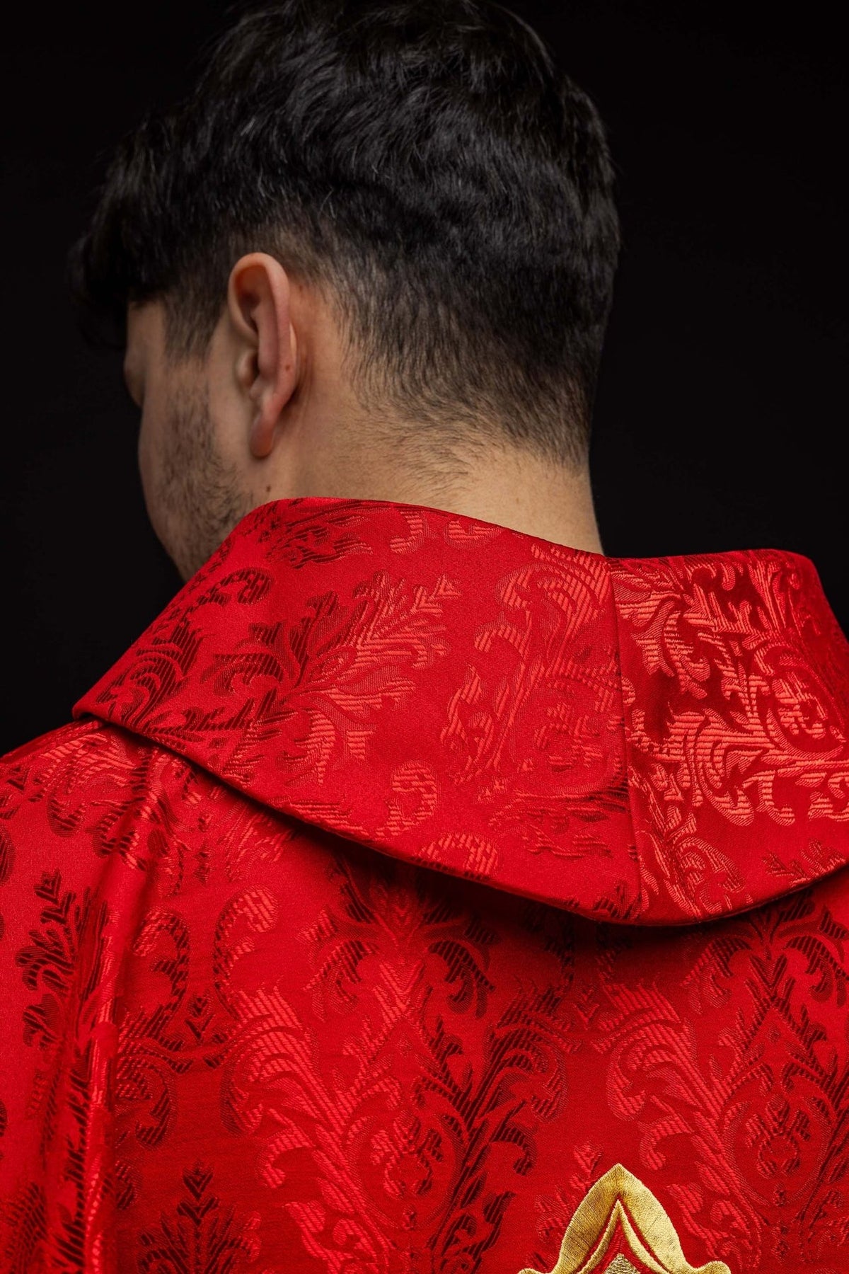 Red chasuble close-up showing the stand-up collar in patterned fabric