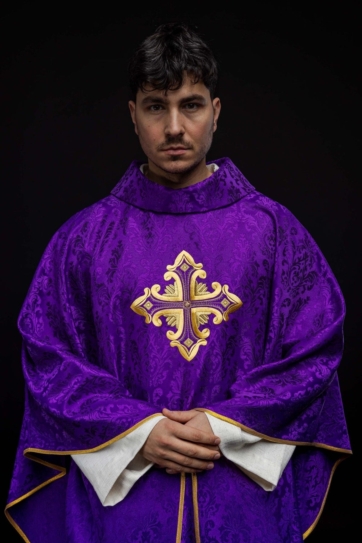 Purple chasuble worn front with gold cross embroidery and stand-up collar