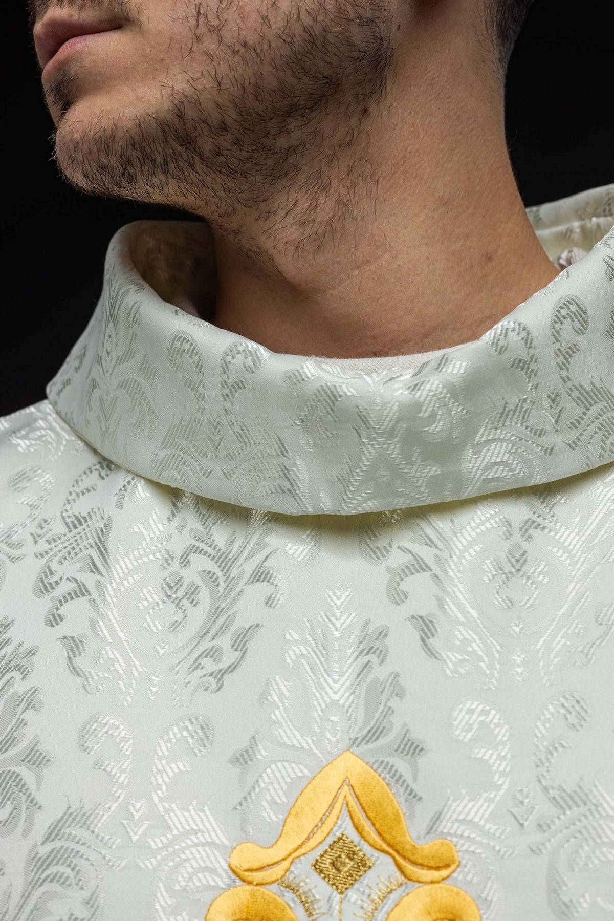 Ecru chasuble close-up of stand-up collar and patterned fabric