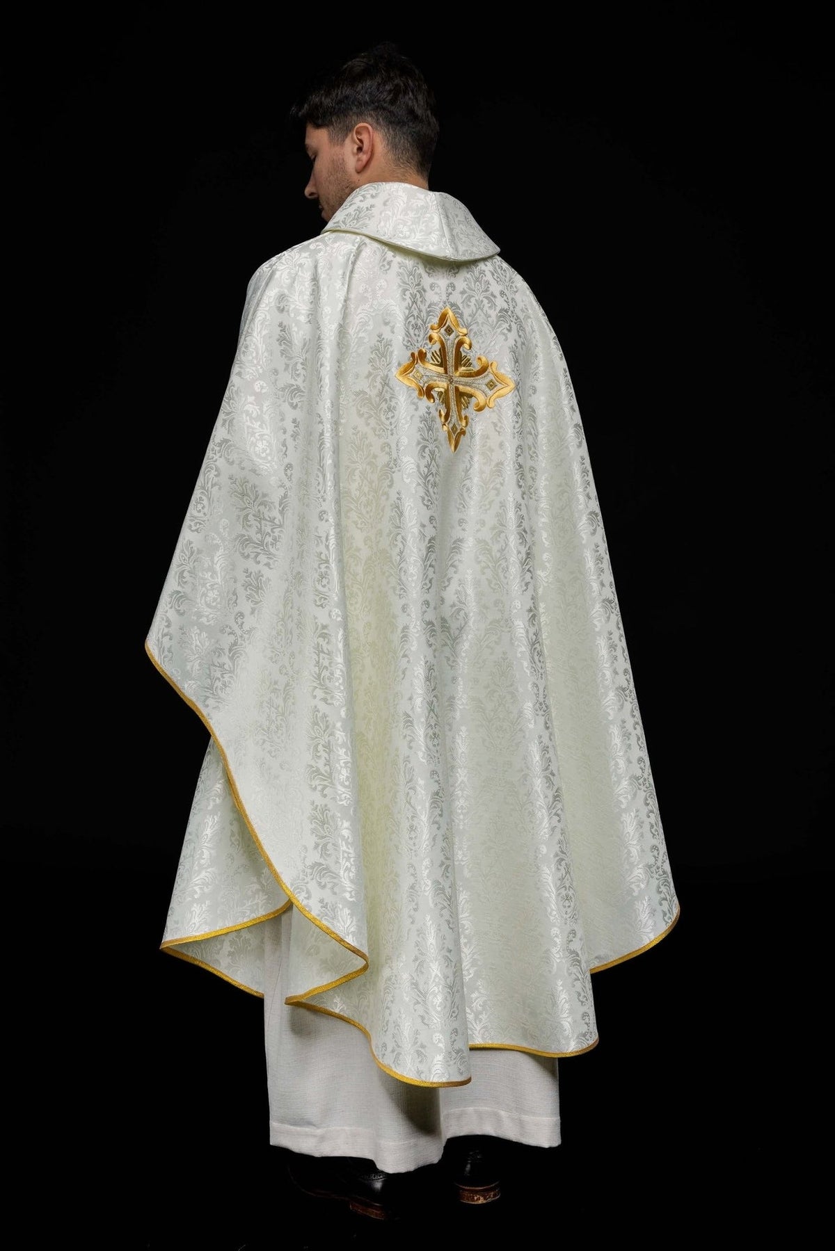 Ecru chasuble back view with gold cross embroidery and gold trim