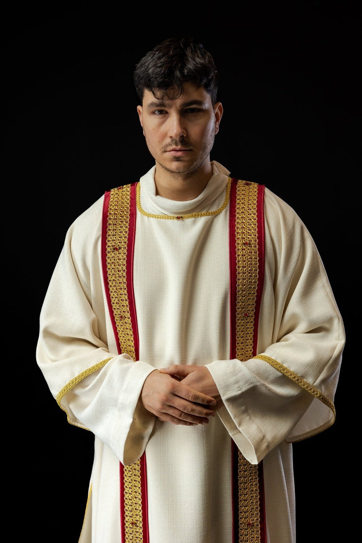 Handcrafted dalmatic front view showing white fabric, red orphreys and gold embroidery