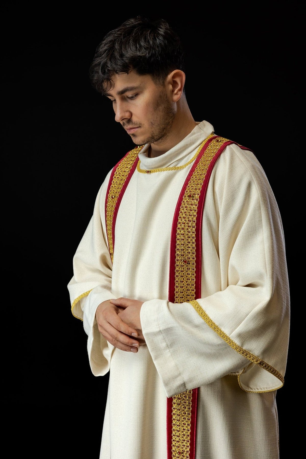 Dalmatic three-quarter view showing white sleeves with gold edging and red orphreys