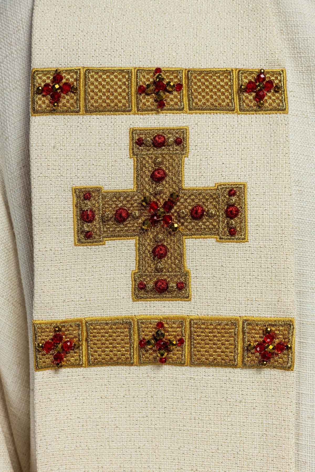 Stole detail showing gold cross embroidery with red and brown stones