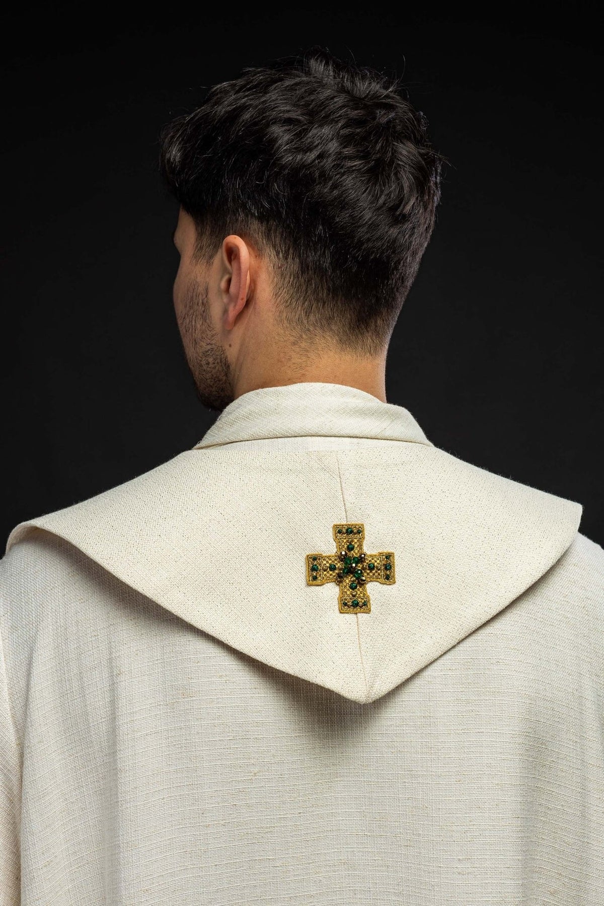Stole back view showing a gold embroidered cross with green stones