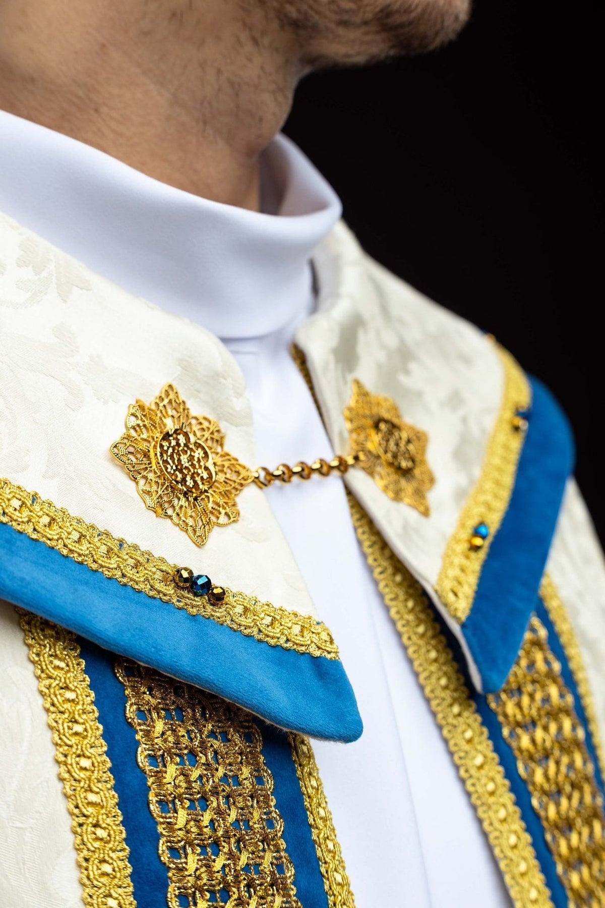 Marian cope side close-up showing blue velvet trim, gold edging and natural stones