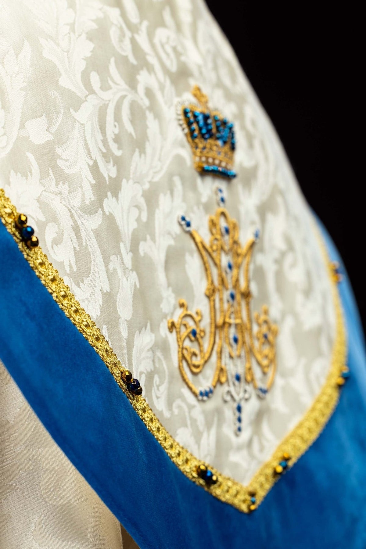 Marian cope gold and blue tassel detail on ecru jacquard fabric