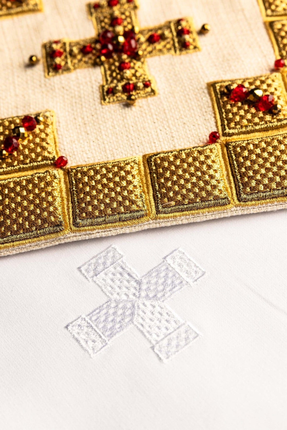Altar linen set folded view with gold embroidery, red stones and white fabric