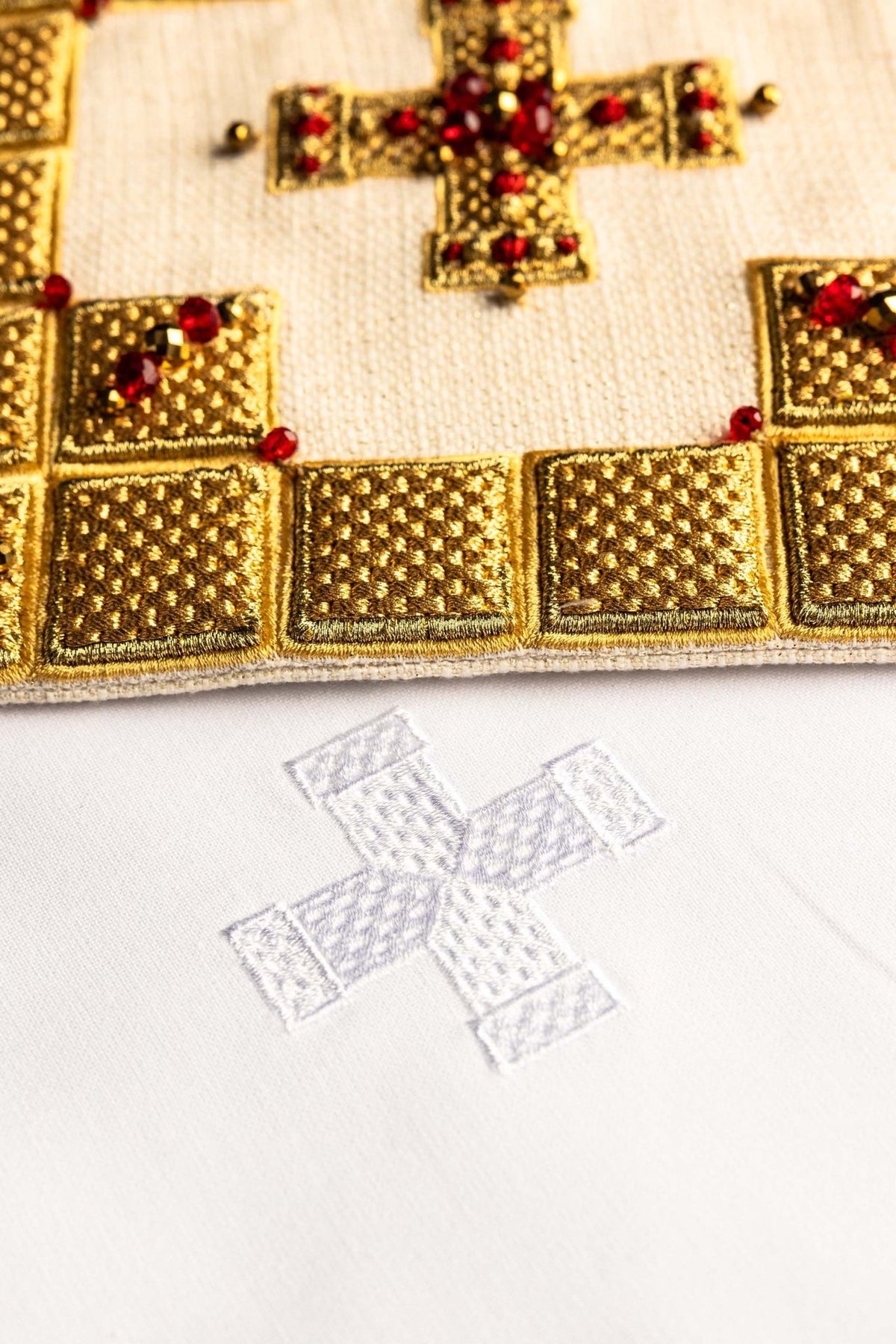 Altar linen set close-up of gold border, cross embroidery and red stones