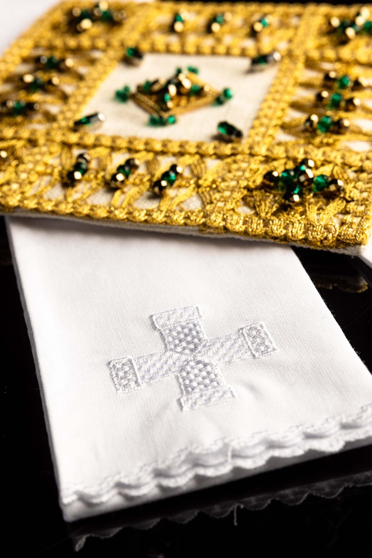 Altar linen set close-up of white linen with silver embroidered cross and scalloped edge