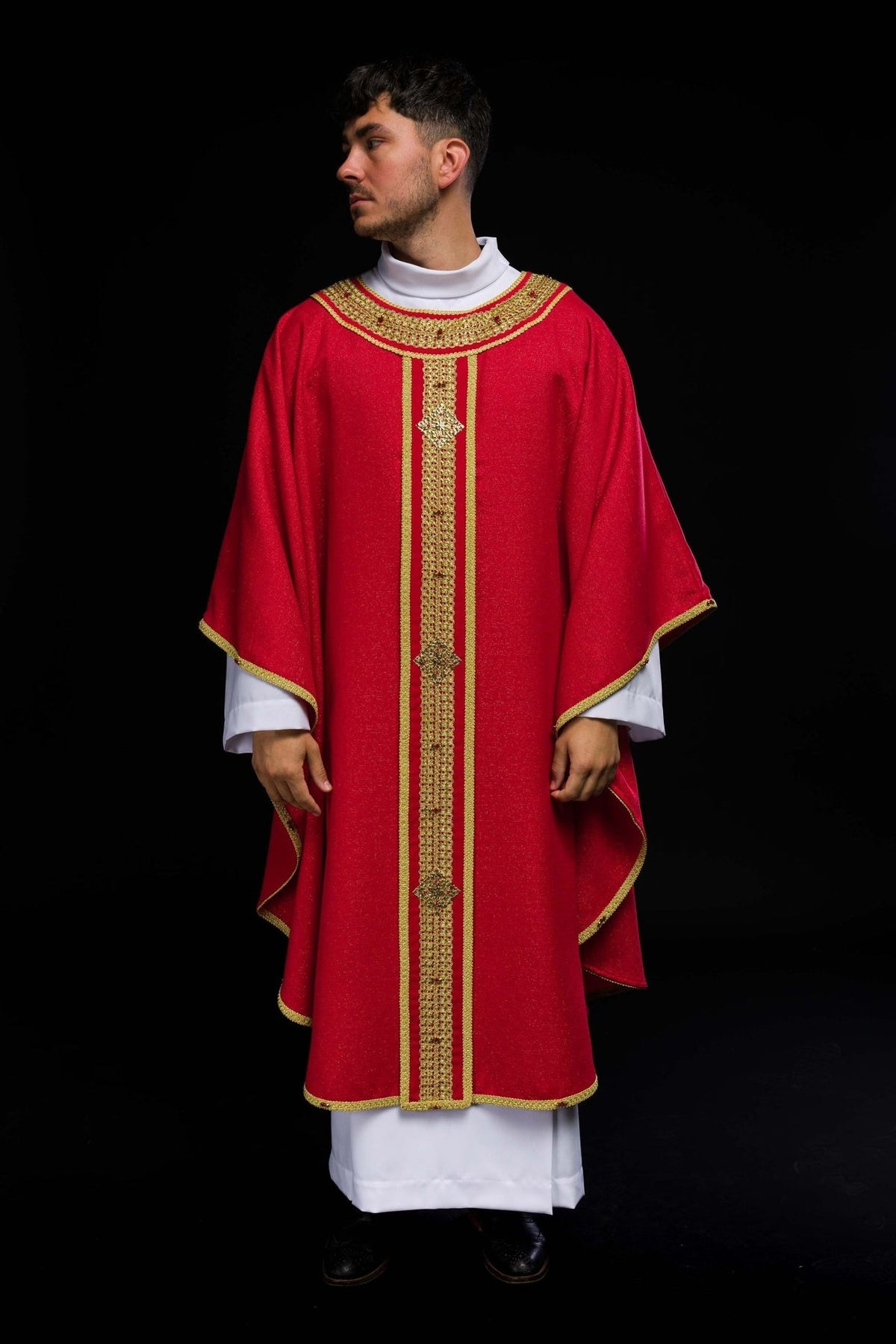 Red chasuble worn front view with gold orphrey and stone embellishments