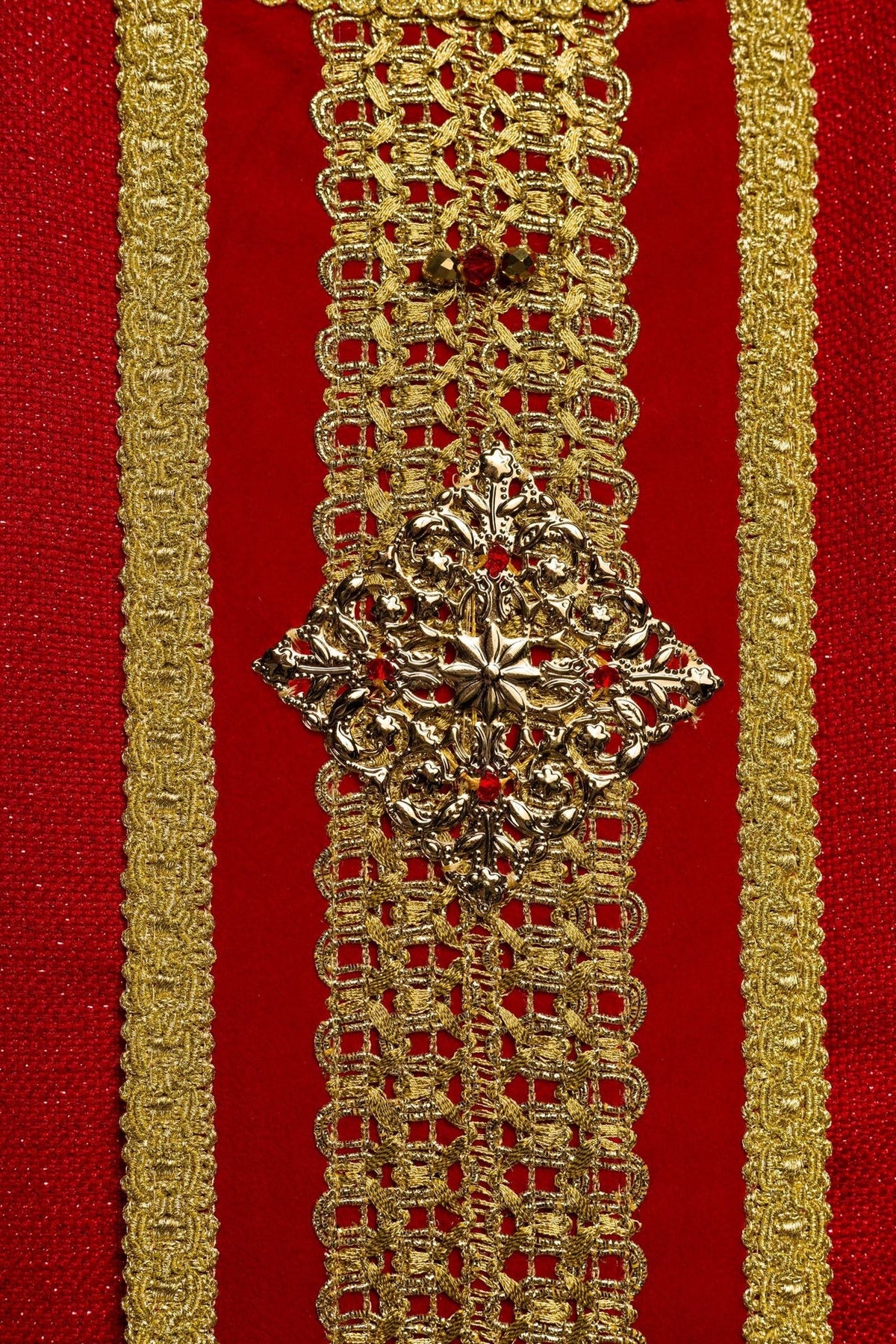 Red chasuble front orphrey close-up with gold embroidery and natural stones
