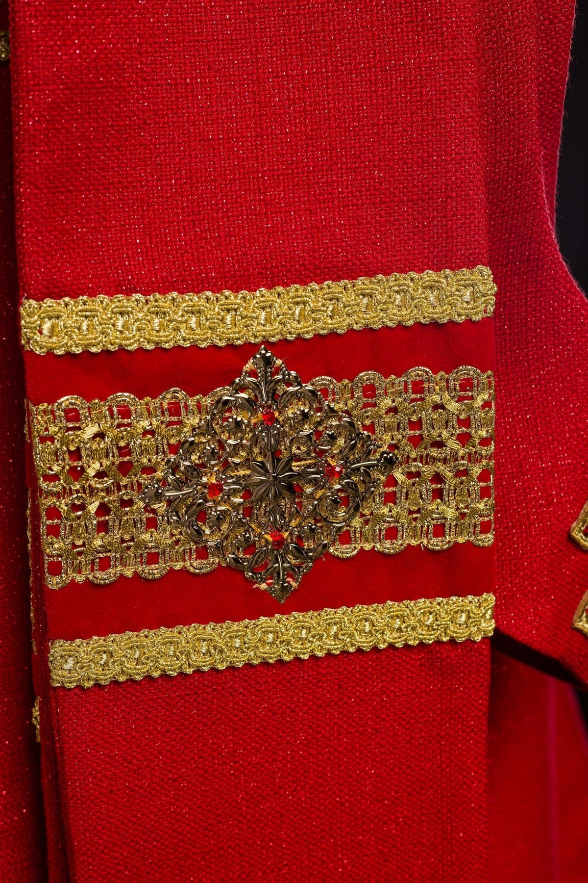 Red chasuble sleeve detail with gold cross embroidery and gold trim