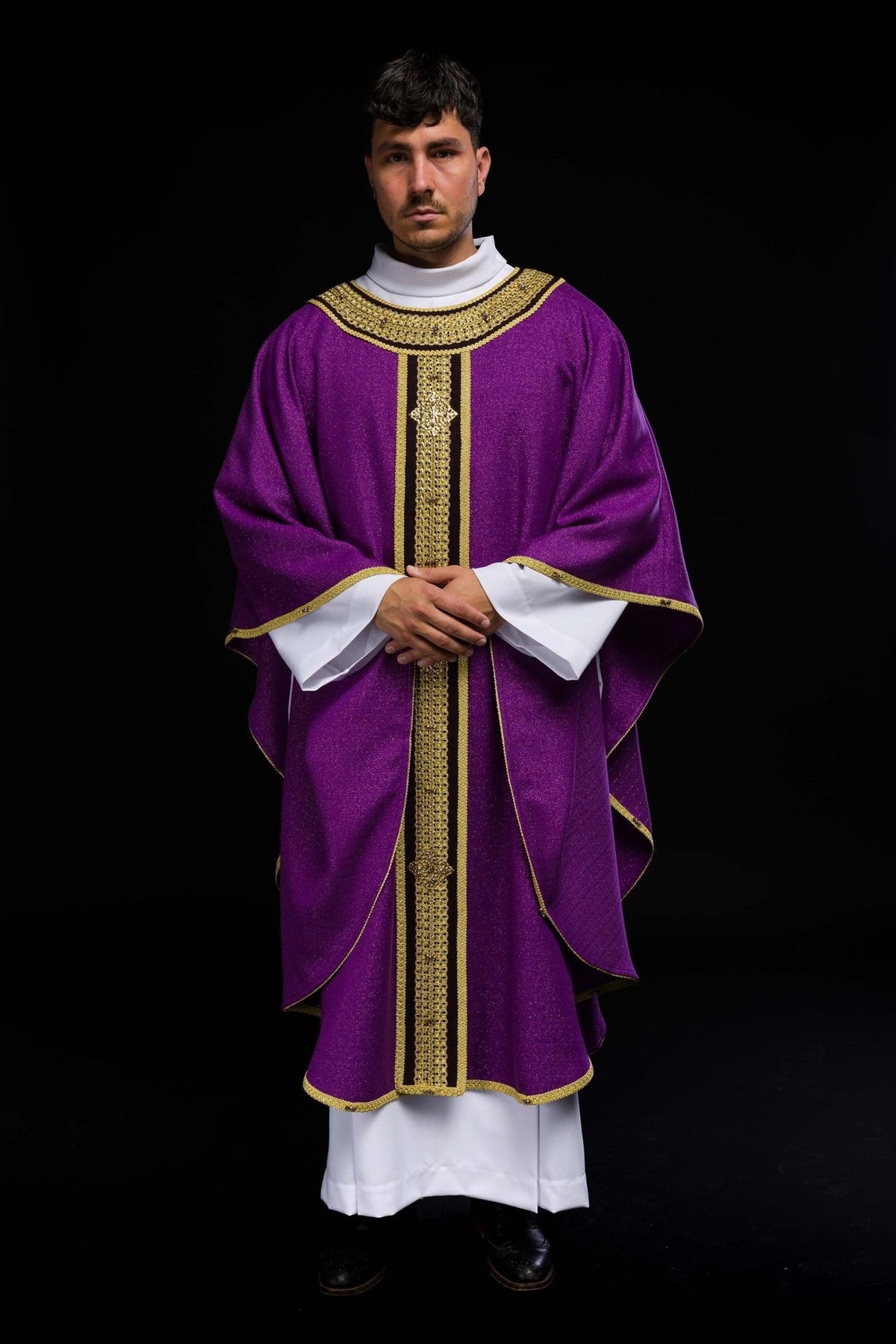 Handcrafted chasuble front view in purple with gold embroidery, black orphrey and natural stones