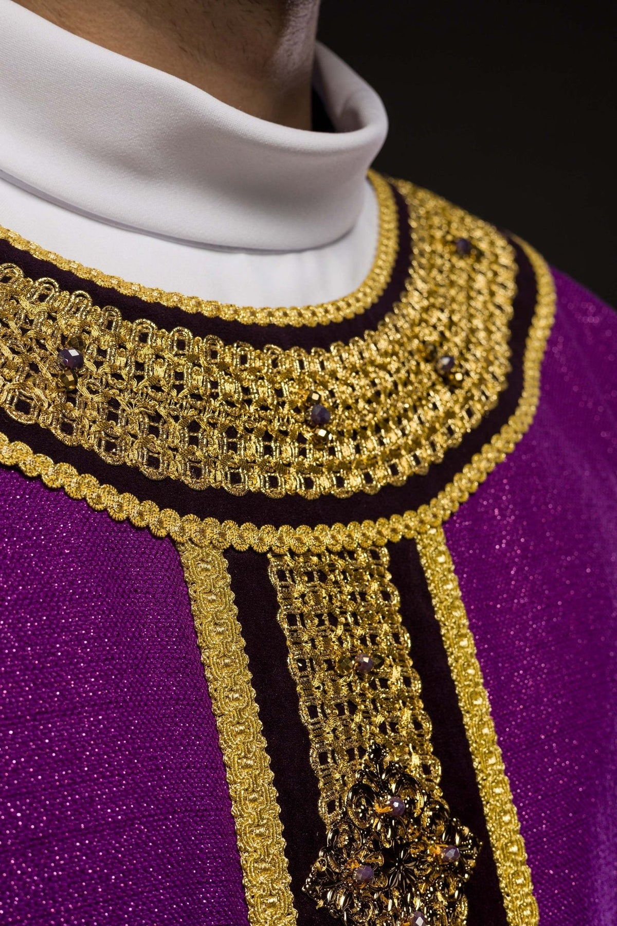 Purple chasuble collar close-up with gold embroidery and natural stones