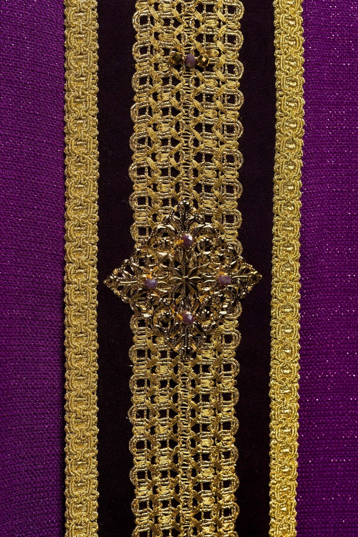 Purple chasuble central gold orphrey close-up with floral ornament and natural stones