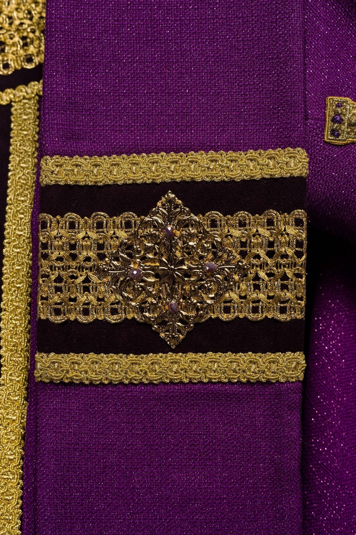 Purple chasuble side detail with gold embroidery, cross motif and tassel