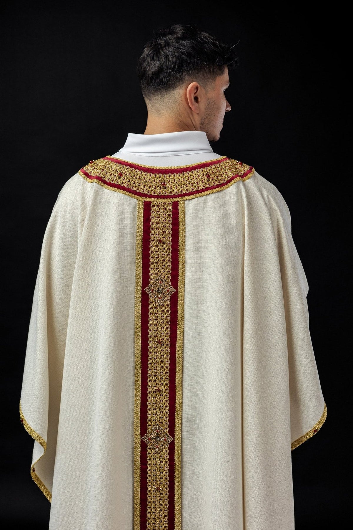 Back close-up of the chasuble with red and gold orphrey and embroidered collar