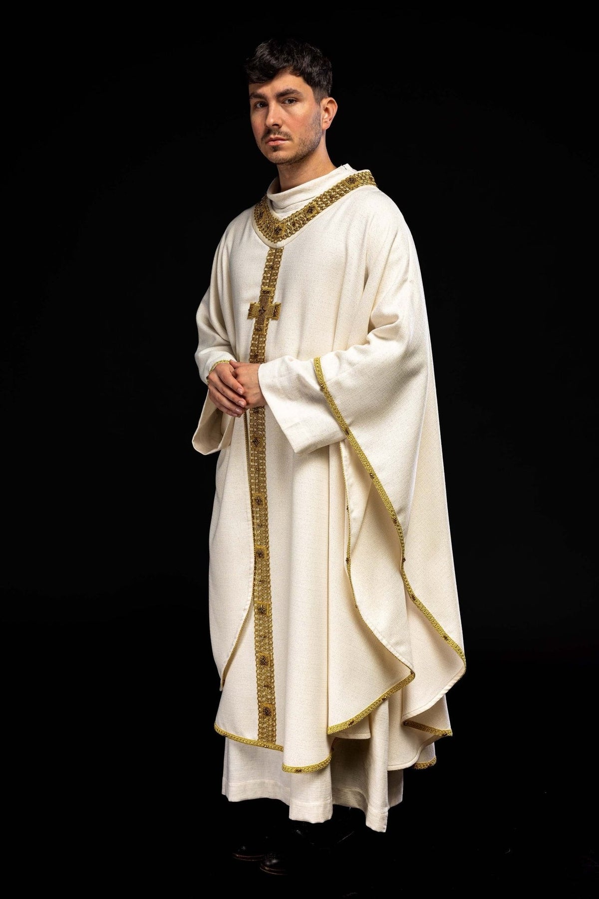 Handcrafted chasuble worn, showing ecru fabric and gold front orphrey