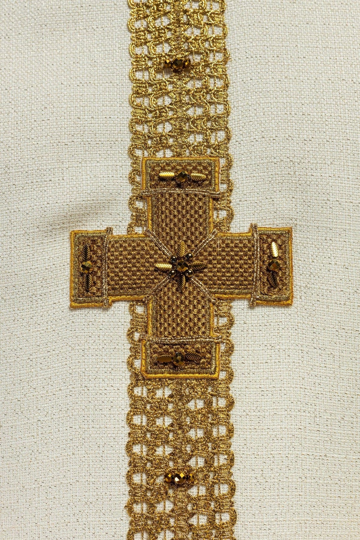 Ecru chasuble cross embroidery close-up with gold and natural stones